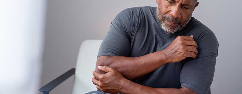 patient suffering from elbow pain in need of chiropractor in Santa Rosa