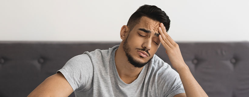patient suffering from headache in need of chiropractor in Santa Rosa